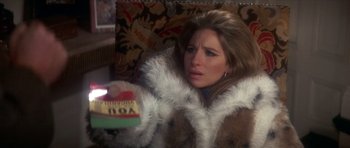 Movie still from “The Owl and the Pussycat” (1970), directed by Herbert Ross – A woman wearing a fur coat holding a box of candy; Close Up shot, High angle
