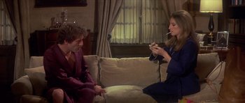 Movie still from “The Owl and the Pussycat” (1970), directed by Herbert Ross – Two people sitting on a couch talking to each other; Medium shot, High angle