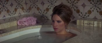 Movie still from “The Owl and the Pussycat” (1970), directed by Herbert Ross – A beautiful woman sitting in a bath tub; Medium shot, High angle