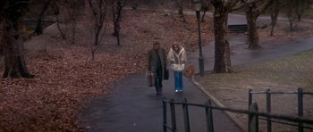 Movie still from “The Owl and the Pussycat” (1970), directed by Herbert Ross – Two people walking down a sidewalk with suitcases; Wide shot, High angle