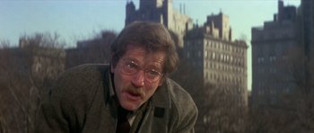 Movie still from “The Owl and the Pussycat” (1970), directed by Herbert Ross – A person wearing glasses and a coat; Close Up shot, Over the shoulder angle