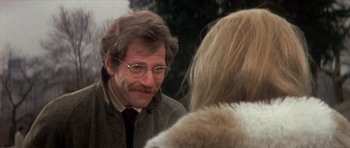 Movie still from “The Owl and the Pussycat” (1970), directed by Herbert Ross – A man wearing glasses and a jacket talking to a woman; Close Up shot, Over the shoulder angle