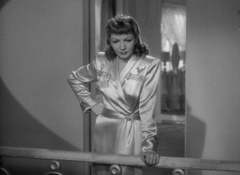 Movie still from “The Palm Beach Story” (1942), directed by Preston Sturges – A black and white photo of a woman in a robe; Medium shot, Low angle