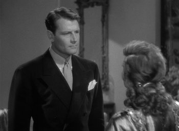 Movie still from “The Palm Beach Story” (1942), directed by Preston Sturges – A man in a suit and tie talking to a woman in a dress suit; Close Up shot, Over the shoulder angle