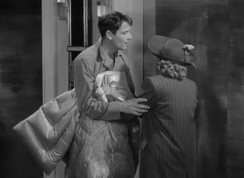 Movie still from “The Palm Beach Story” (1942), directed by Preston Sturges – A man and a woman standing next to each other; Medium shot, High angle