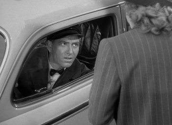 Movie still from “The Palm Beach Story” (1942), directed by Preston Sturges – An old photo of a man looking out of a car window; Close Up shot, Over the shoulder angle
