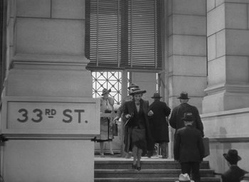 Movie still from “The Palm Beach Story” (1942), directed by Preston Sturges – A group of people walking down a set of stairs; Wide shot, Low angle