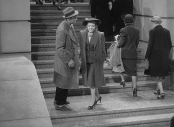 Movie still from “The Palm Beach Story” (1942), directed by Preston Sturges – An old photo of a man and a woman walking down the stairs; Wide shot, High angle