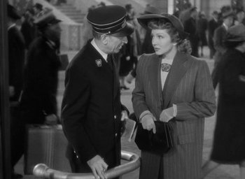 Movie still from “The Palm Beach Story” (1942), directed by Preston Sturges – An old black and white photo of a man and a woman talking; Medium shot, High angle