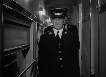 Movie still from “The Palm Beach Story” (1942), directed by Preston Sturges – A black and white photo of a man in a uniform; Medium shot, Low angle