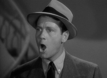 Movie still from “The Palm Beach Story” (1942), directed by Preston Sturges – A man in a suit and a hat with his mouth wide open; Close Up shot, Low angle