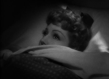 Movie still from “The Palm Beach Story” (1942), directed by Preston Sturges – An old black and white photo of a woman laying in a bed; Close Up shot, Overhead angle