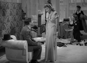 Movie still from “The Palm Beach Story” (1942), directed by Preston Sturges – A man and a woman are sitting on a couch in a living room; Medium shot, High angle