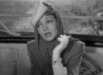 Movie still from “The Palm Beach Story” (1942), directed by Preston Sturges – An old black and white photo of a woman wearing a hat; Close Up shot, Low angle
