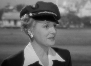 Movie still from “The Palm Beach Story” (1942), directed by Preston Sturges – An old photo of a woman wearing a hat; Close Up shot, Low angle