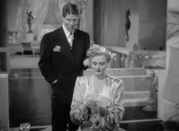 Movie still from “The Palm Beach Story” (1942), directed by Preston Sturges – A man and a woman standing next to each other; Medium shot, High angle