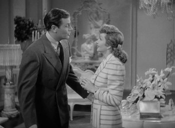 Movie still from “The Palm Beach Story” (1942), directed by Preston Sturges – A man and a woman talking to each other; Medium shot, Over the shoulder angle