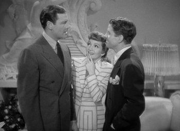 Movie still from “The Palm Beach Story” (1942), directed by Preston Sturges – Two men and a woman standing next to each other; Medium shot, High angle
