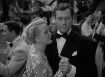 Movie still from “The Palm Beach Story” (1942), directed by Preston Sturges – A man and a woman are dancing in a crowd; Medium shot, Low angle