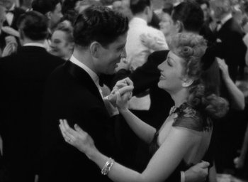 Movie still from “The Palm Beach Story” (1942), directed by Preston Sturges – A man and a woman dancing together at a party; Medium shot, High angle