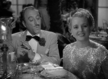 Movie still from “The Palm Beach Story” (1942), directed by Preston Sturges – A man and a woman sitting at a dinner table; Medium shot, Over the shoulder angle