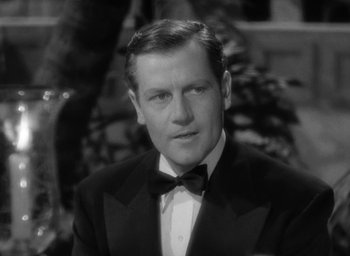 Movie still from “The Palm Beach Story” (1942), directed by Preston Sturges – A black and white photo of a man in a tuxedo; Close Up shot, High angle