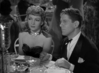 Movie still from “The Palm Beach Story” (1942), directed by Preston Sturges – A man and a woman sitting at a dinner table; Medium shot, Over the shoulder angle