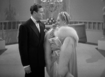 Movie still from “The Palm Beach Story” (1942), directed by Preston Sturges – A man and a woman standing next to each other; Medium shot, High angle