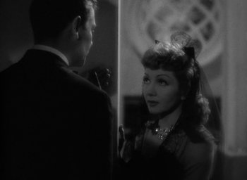 Movie still from “The Palm Beach Story” (1942), directed by Preston Sturges – A man and a woman are standing in front of a mirror; Close Up shot, Over the shoulder angle