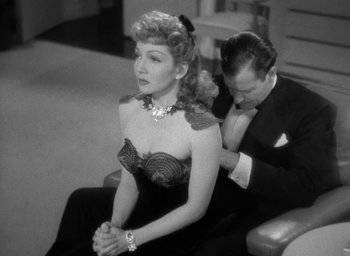Movie still from “The Palm Beach Story” (1942), directed by Preston Sturges – A man and a woman sitting next to each other on a couch; Medium shot, High angle