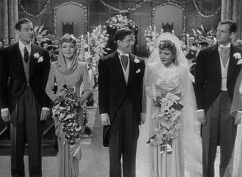 Movie still from “The Palm Beach Story” (1942), directed by Preston Sturges – A man and two women standing next to each other; Wide shot, High angle