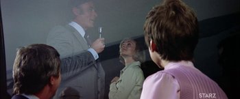 Movie still from “The Parallax View” (1974), directed by Alan J. Pakula – A man and a woman are looking in a mirror; Medium shot, Low angle