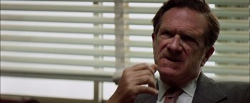 Movie still from “The Parallax View” (1974), directed by Alan J. Pakula – A person talking on a cell phone; Close Up shot, Low angle