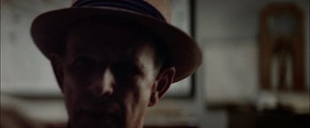 Movie still from “The Parallax View” (1974), directed by Alan J. Pakula – A person wearing a hat; Extreme Close Up shot, Low angle