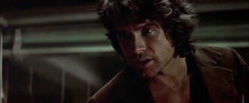 Movie still from “The Parallax View” (1974), directed by Alan J. Pakula – A person wearing a brown jacket; Close Up shot, Low angle