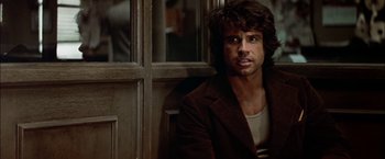 Movie still from “The Parallax View” (1974), directed by Alan J. Pakula – A man sitting in front of a window; Close Up shot, Low angle