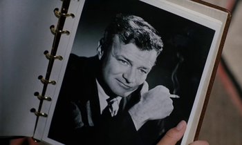 Movie still from “The Parent Trap” (1961), directed by David Swift – An old photo of a man smoking a cigarette; Extreme Close Up shot, High angle