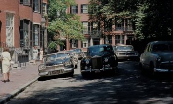 Movie still from “The Parent Trap” (1961), directed by David Swift – A group of cars parked on the side of the street; Extreme Wide shot, High angle