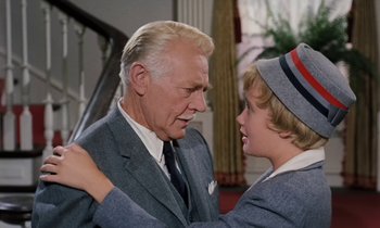 Movie still from “The Parent Trap” (1961), directed by David Swift – An older man and a young boy in a room; Medium shot, Over the shoulder angle