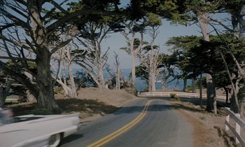 Movie still from “The Parent Trap” (1961), directed by David Swift – A truck driving down a road next to trees; Extreme Wide shot, High angle