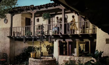 Movie still from “The Parent Trap” (1961), directed by David Swift – People are standing on the balcony of a building; Extreme Wide shot, Low angle