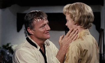 Movie still from “The Parent Trap” (1961), directed by David Swift – An older man and a young boy looking at each other; Close Up shot, Over the shoulder angle
