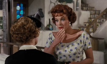 Movie still from “The Parent Trap” (1961), directed by David Swift – An older woman sitting next to a younger woman; Medium shot, Over the shoulder angle