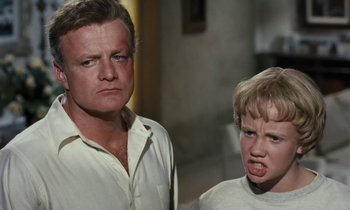 Movie still from “The Parent Trap” (1961), directed by David Swift – A man and a young boy standing next to each other; Close Up shot, Low angle