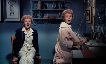 Movie still from “The Parent Trap” (1961), directed by David Swift – A couple of people that are sitting in a room together; Medium shot, High angle