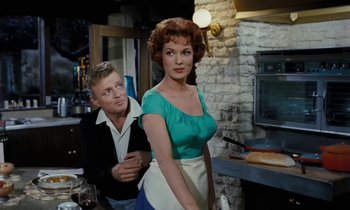 Movie still from “The Parent Trap” (1961), directed by David Swift – A man and a woman standing in front of a brick wall; Medium shot, Over the shoulder angle