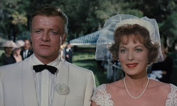 Movie still from “The Parent Trap” (1961), directed by David Swift – A man and a woman standing next to each other; Close Up shot, Over the shoulder angle