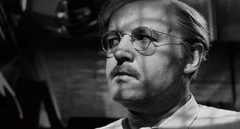 Movie still from “The Pawnbroker” (1964), directed by Sidney Lumet – An older man wearing glasses and a tie; Close Up shot, Low angle