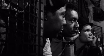 Movie still from “The Pawnbroker” (1964), directed by Sidney Lumet – A couple of men sitting next to each other; Close Up shot, Over the shoulder angle