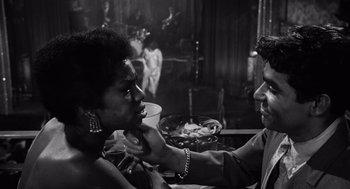 Movie still from “The Pawnbroker” (1964), directed by Sidney Lumet – A black and white photo of a woman getting her makeup done; Close Up shot, Over the shoulder angle